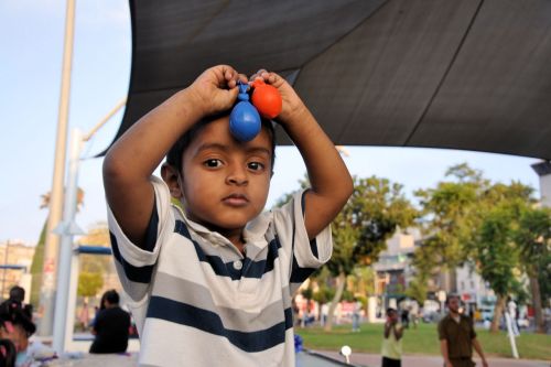 Israel: Children in Israel - Lewinsky Garden, South Tel-Aviv - hild at Playschool, playing with water balloons