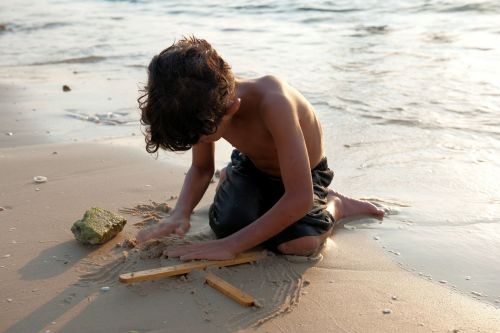 Israel: Children in Israel - Jisr az-Zarqa, Mediterranean: Boy playing on beach.