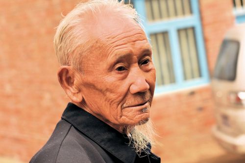 Old-Age - China: Reflective old man at the market